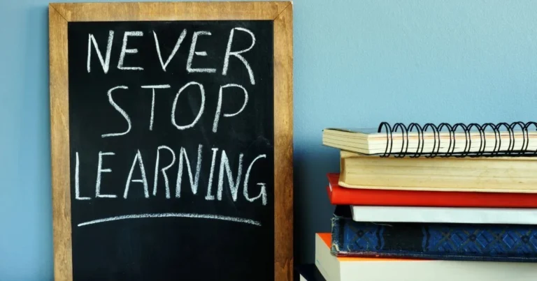 A chalkboard sign that says never stop learning.