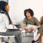 A polyamory coach and their clients doing a sex coaching and polyamory coaching session.