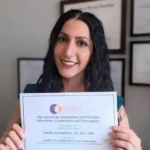 Lilithfoxx holding her AASECT certification certificate. She is a polyamory and kink coach.