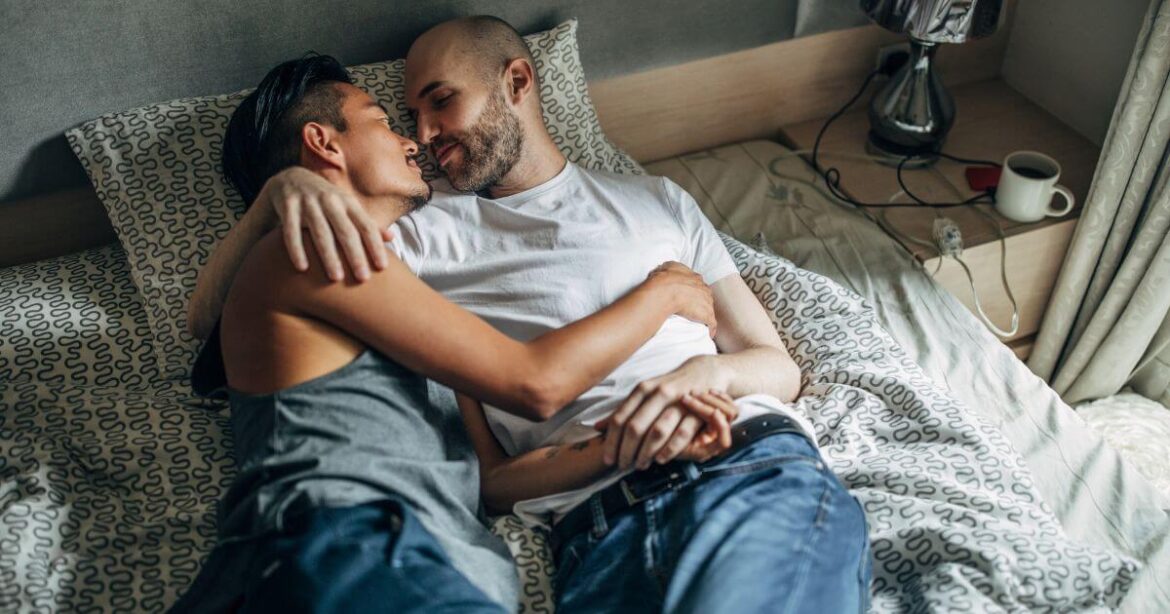 Understanding Aftercare: Essential Insights into Post-Play Recovery A couple intimately cuddling in bed, demonstrating what is aftercare.
