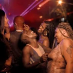 BIPOC individuals dancing at a party, exemplifying community and creating inclusive kink events.
