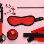 BDSM classes background of toys on a pink sheet.