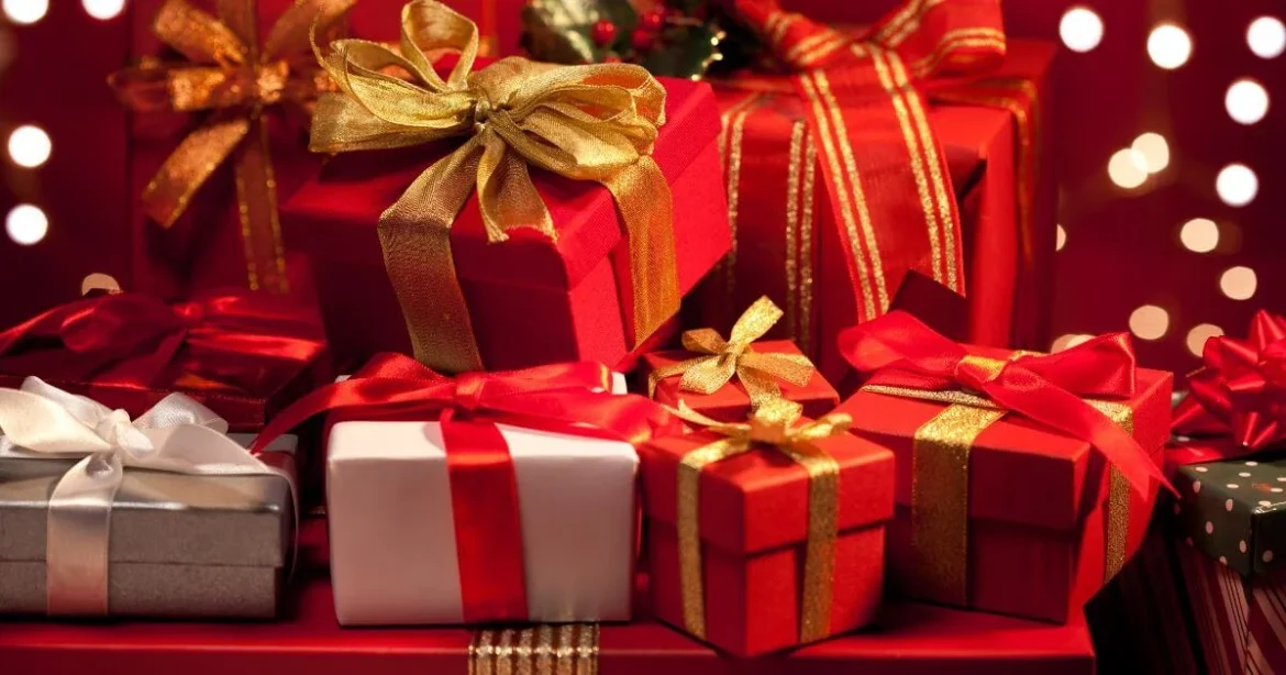 Top 10 BDSM Christmas Gift Ideas for the Kinkster in Your Life A festive background with BDSM Christmas gifts beneath a tree.