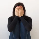 A young woman struggling with guilt and self-doubt in BDSM.