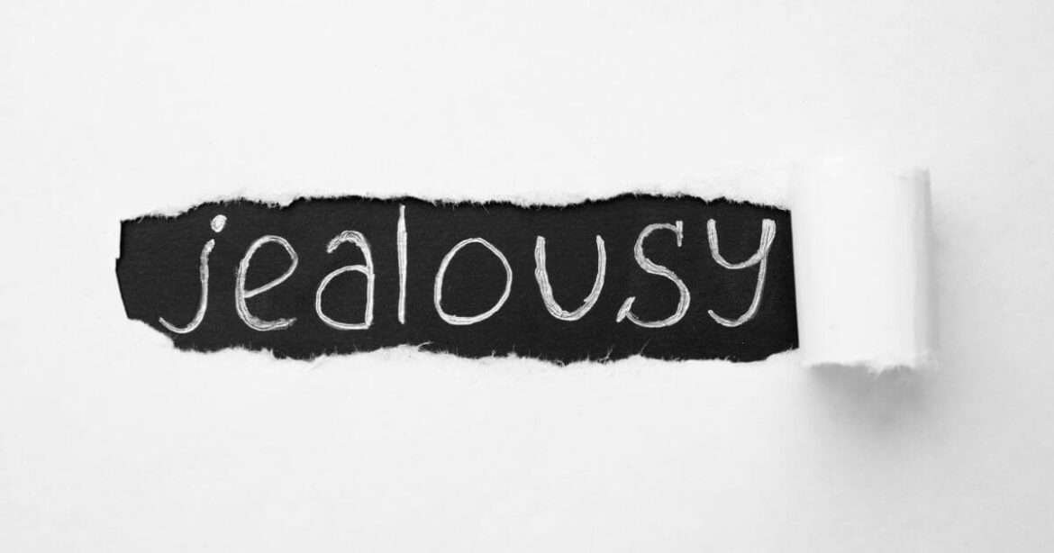 How to Manage Jealousy in BDSM Dynamics jealousy in BDSM. Written on a notebook.
