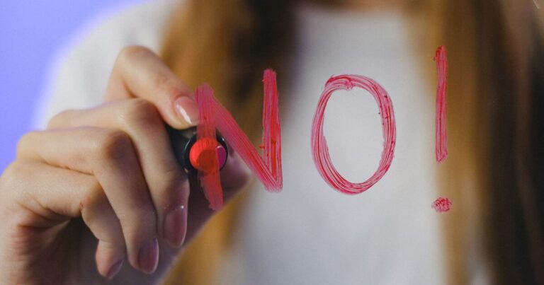 Safe words BDSM. Woman writing no on mirror in lipstick.